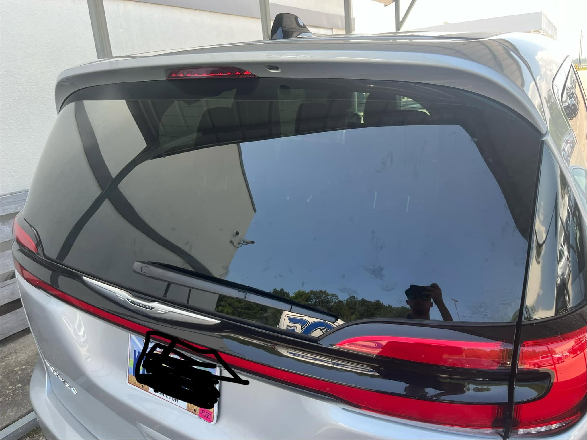 Technician finishing a windshield seal