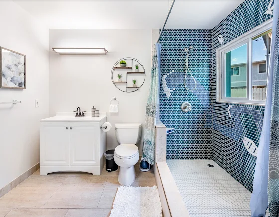 Lemon Home Cleaning team member wiping down a spotless bathroom countertop